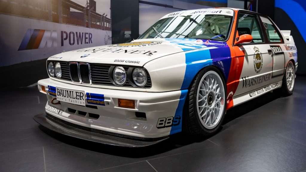 A BMW M3 race car on display in a museum